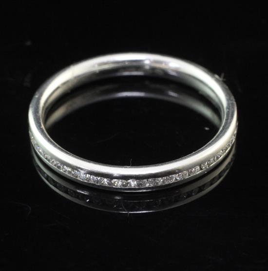 A modern platinum and diamond set full eternity ring, size M.